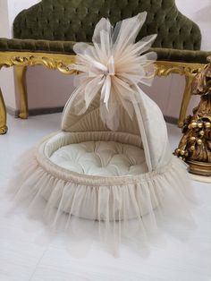 a chair with a white tulle skirt on it and a bow in the back