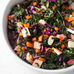 a white bowl filled with salad and carrots