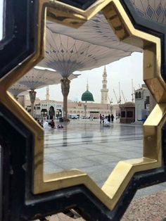 the reflection of an ornate building is seen through a mirror in front of some other buildings