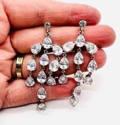 Gorgeous long vintage sparkly Austrian crystal drop dangle earrings. Rhodium plated metal set with best quality sparkling pear shaped Austrian crystals. Posts for pierced ears. The backs are new backs I added to the earrings. Excellent vintage condition with minimal age appropriate wear. Measure 2 3/8 inches long by 1 inch wide. Cubic Zirconia Drop Chandelier Earrings, Dazzling Crystal Drop Chandelier Earrings, Crystal Pear-shaped Chandelier Earrings For Parties, Glamorous Cubic Zirconia Drop Chandelier Earrings, Drop Chandelier Earrings With Sparkling Stones, Dangle Crystal Earrings With Bling For Anniversary, Glamorous Pear-shaped Crystal Teardrop Earrings, Crystal Drop Chandelier Earrings With Sparkling Stones, Glamorous Chandelier Drop Earrings With Sparkling Stones