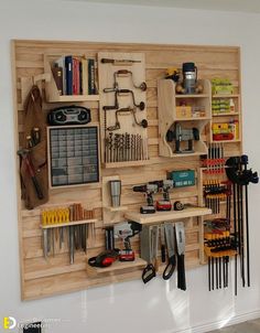 a workbench with many tools on it mounted to the side of a wall