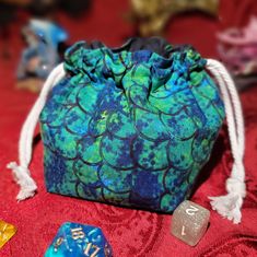 the dice bag is blue and green with white trimmings on it's sides