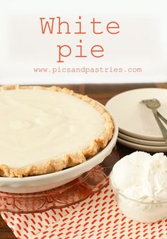 a pie sitting on top of a table next to plates