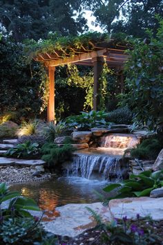 a small waterfall in the middle of a garden