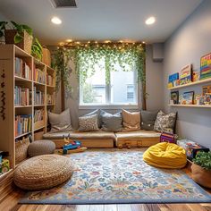 a living room filled with lots of furniture and bookshelves next to a window