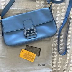 Baby Light Blue Fendi Baguette With Convertible Straps With Authenticity Card. Still Has Compact Mirror Wrapped In Plastic. Light Corner Wear On 2 Corners As Seen In Pics. Comes With Dust Bag, 2 Straps, Compact Mirror, Authenticity Card. Excellent Shape. Designer Baguette Bag With Branded Hardware, Luxury Blue Baguette Bag, Luxury Blue Rectangular Baguette Bag, Modern Blue Rectangular Baguette Bag, Luxury Blue Baguette Bag For Everyday Use, Designer Everyday Baguette Bag, Elegant Blue Baguette Bag With Detachable Strap, Elegant Blue Baguette Bag For Shopping, Elegant Blue Baguette Bag For Evening