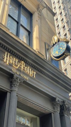 the entrance to harry potter new york with a large clock on it's side