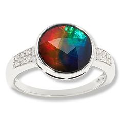 Discover the mesmerizing allure of the Canadian Ammolite Gems Sterling Silver Round Ammolite Ring by Kenneth Bradley. This exquisite piece showcases a vibrant, multicolored Ammolite/Quartz triplet, a rare gemstone known for its dazzling array of natural hues, sourced from Alberta, Canada.

- Material: Sterling Silver (.925) with rhodium plating
- Size: 9
- Color: Silver
- Gemstone: Round 10mm multicolor Ammolite/Quartz triplet, bezel-set
- Design Features: Beaded accents on the ring shoulders, a Ammolite Ring, Ammolite Jewelry, Original Jewelry Design, Rare Gems, Rare Gemstones, Original Jewelry, Alberta Canada, Gems Jewelry, Natural Colors