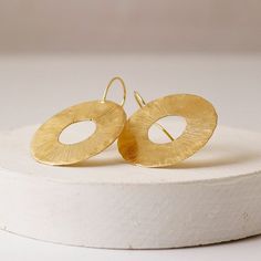 A striking pair of large circle drop earrings with cut out detail, uniquely finished with a scratchy textured and organic surface.These lovely statement circle earrings come in a choice of sterling silver or 18ct gold plated sterling silver. They are so eye-catching and the textured surface catches the light beautifully.These earrings are most unique and of a substantial size - they will add drama to any outfit without being too fussy. A lovely gift for any occasion, or of course to ones self; t Modern Textured Drop Earrings, Modern Textured Round Earrings, Modern Hammered Circle Earrings, Textured Round Earrings For Gifts, Modern Hammered Open Circle Earrings, Large Drop Earrings, Hamsa Necklace, Constellation Necklace, Branded Gifts