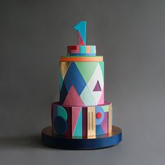 a multi - colored cake with geometric designs on it