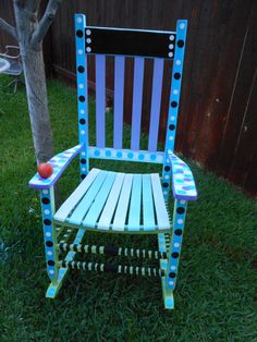 a blue and white chair sitting in the grass