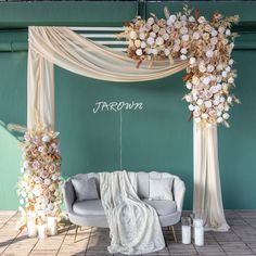 a white couch sitting under a wedding arch