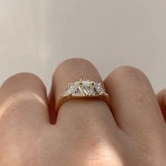 a woman's hand with a diamond ring on it