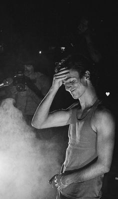 black and white photograph of a man holding his head