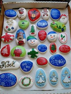 a box filled with lots of colorful rocks covered in different designs and words on them