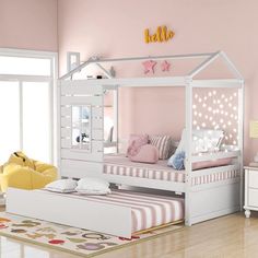 a child's bedroom with pink walls, white furniture and a canopy bed in the middle