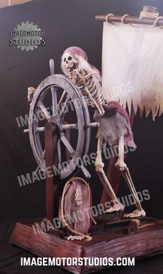 a skeleton is sitting on top of a spinning wheel