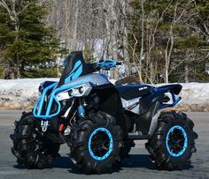 a blue and black four - wheeled vehicle parked in a parking lot