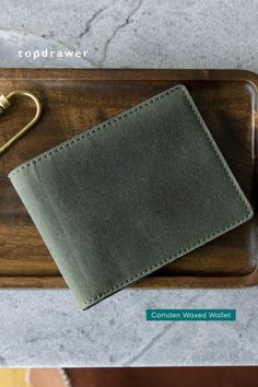 a wallet sitting on top of a wooden tray