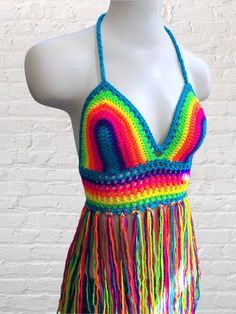 a woman's swimsuit with multicolored crochet fringes on it