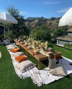 an outdoor dining table set up on the grass