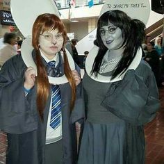 two people dressed up as harry potter and hermile from the wizard's tail