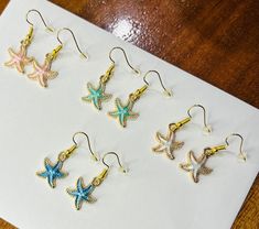 Colourful starfish-shaped earrings that are perfect for the beach! Available in a range of beach-ey, pastel colours, these gorgeous earrings glisten around the edges to enhance their fun shape. Browse our other starfish and shell themed earrings for more selection! White Star Earrings For Beach, Ocean-inspired Star Earrings For The Beach, Ocean-inspired Star Earrings For Beach, Star-shaped Ocean-inspired Earrings For Beach, Summer Beach Earrings With Starfish Charm, Star-shaped Earrings For Beach With Pierced Ears, White Starfish Earrings For Beach, Star-shaped Earrings For The Beach, Star-shaped Summer Beach Earrings