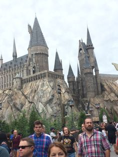 people are standing in front of hogwarts castle at the wizard's village