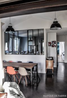 the dining room table is surrounded by mirrors