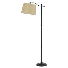 a floor lamp with a beige shade on it's side and a black base