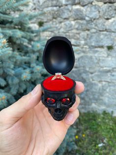 Original gothic skull casket for a ring. This will be a great addition to your marriage proposal. Or it can be used as a nice ring holder. It is produced by the method of sculpting, removing from the mold and casting.  The eyes are encrusted with jewelry inserts (cubic zirconium). It shimmers beautifully in the sun. The pillow is made of red velor. Coolly shows the beauty of the ring. The cover is held in any position and does not wobble. The maximum length of the ring that can fit is 31mm (1.2 inches) I can also personalize the box with your initials and date which I can write on the inside of the box. Or make an inscription of several words as you wish. I can also change the elements of the casket as you wish (Colour of the casket, pillow, hinges, or eyes) Gothic Ring Box, Ring Bearer Pillows, Gothic Skull, Gothic Rings, Marriage Proposal, Skull Ring, Ring Bearer, The Ring, Ring Box