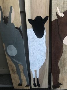 three pieces of wood with animals painted on them