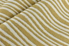 a close up view of a yellow and white striped fabric