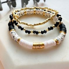 "PLEASE READ ENTIRE DESCRIPTION BEFORE ORDERING! **PLEASE DOUBLE CHECK YOUR SHIPPING ADDRESS IS LISTED CORRECTLY WITH ETSY BEFORE PLACING YOUR ORDER!! **This listing is for ONE bracelet** STRETCHY Beads: 6mm Vinyl Heishi Beads - Colors are Black, White, Speckled Gray with gold coin accents 4mm glass beads with 3mm 14k gold plated accent beads 3mm 14k gold plated diamond cut beads *Nickel & Lead Free* HOW TO ORDER: Select which style you wish to purchase from drop-down (see photos) Select your si Black Clay Bracelet Ideas, Bracelet Organization Ideas, Stretchy Bracelets Diy, Heishi Jewelry, Heishi Bracelets, Layering Bracelets, Clay Bracelets, Dope Jewelry Accessories, Bracelet Layering