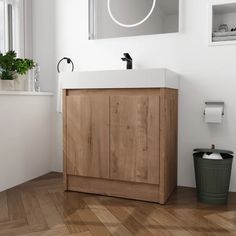 a bathroom with a sink, mirror and trash can