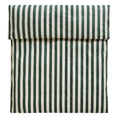 a green and white striped pillow on a white background