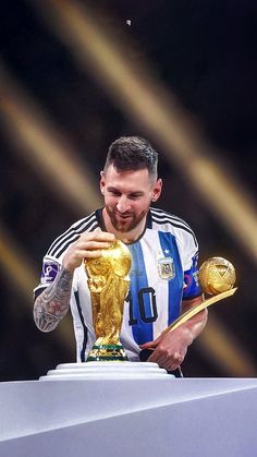 a man holding a golden trophy in his hands