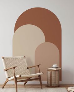 a chair and side table in front of a wall with an arch design on it