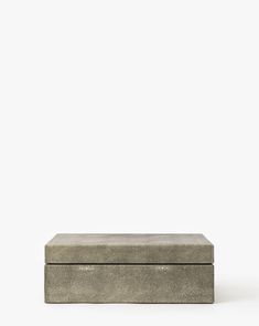 a concrete box sitting on top of a white surface