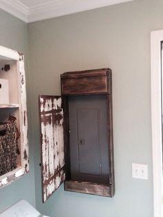 an old wooden box is hanging on the wall