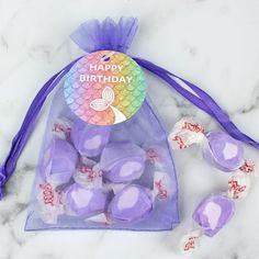 a bag filled with purple and white candies on top of a marble countertop