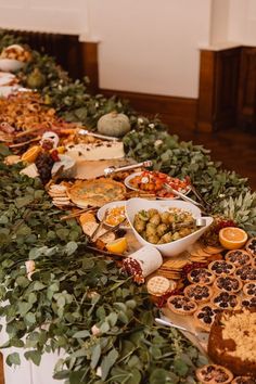 a long table filled with lots of different types of food on top of each other