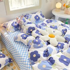 a bed with blue and white flowers on it