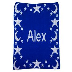 a blue and white knitted pillow with stars and crescents on it, which says alex