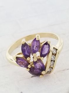 Purple Multi-stone Amethyst Ring, Purple Multi-stone Amethyst Ring Fine Jewelry, Fine Jewelry Purple Amethyst Multi-stone Ring, Formal Purple Gemstone Cluster Ring, Purple Multi-stone Amethyst Ring In Fine Jewelry Style, Purple Gemstone Cluster Ring For Formal Occasions, Multi-stone Amethyst Ring In Yellow Gold, Heirloom Purple Rings With Gemstone Accents, Purple Cluster Ring With Accent Stones