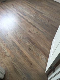 an empty room with hard wood floors and white doors