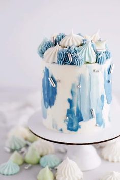 a blue and white cake sitting on top of a table