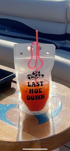 a plastic cup sitting on top of a wooden table