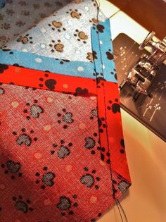 a close up of a tie on top of a table with sewing machine in the background