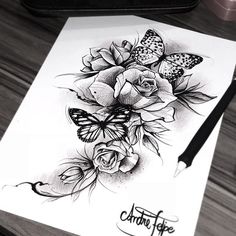 a black and white drawing of roses with butterflies on it's side, next to a pen